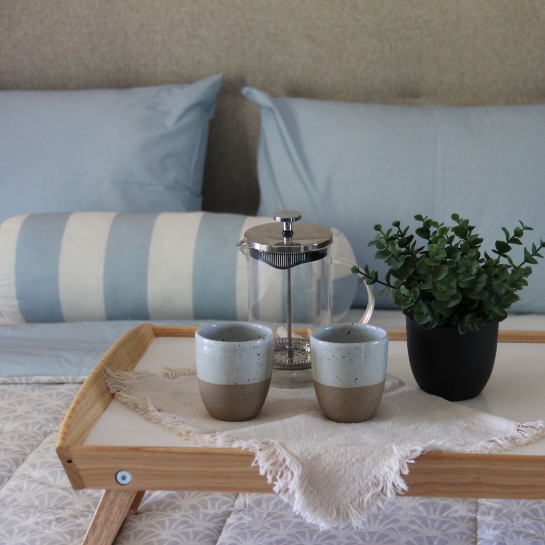 Blue and white comforter set with breakfast tray