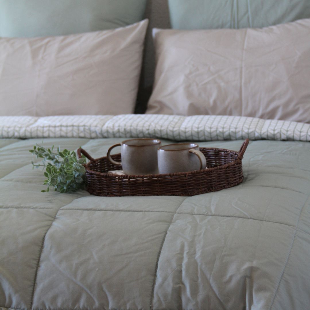 Close up of a sage green comforter set